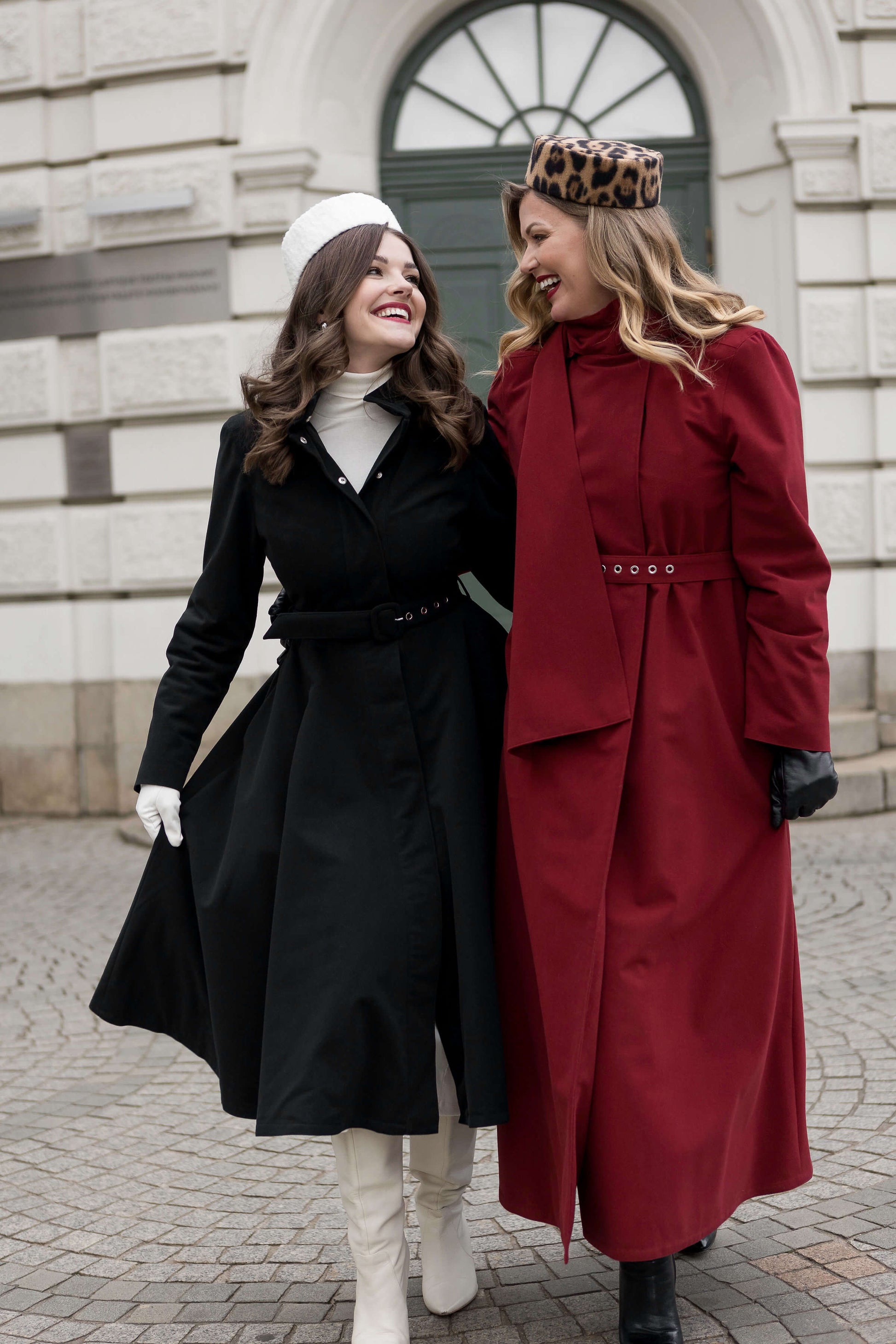 Elegant women’s long coat in maroon red, styled with scarf and matching belt for chic winter looks and obsidian frost black winter coat. 