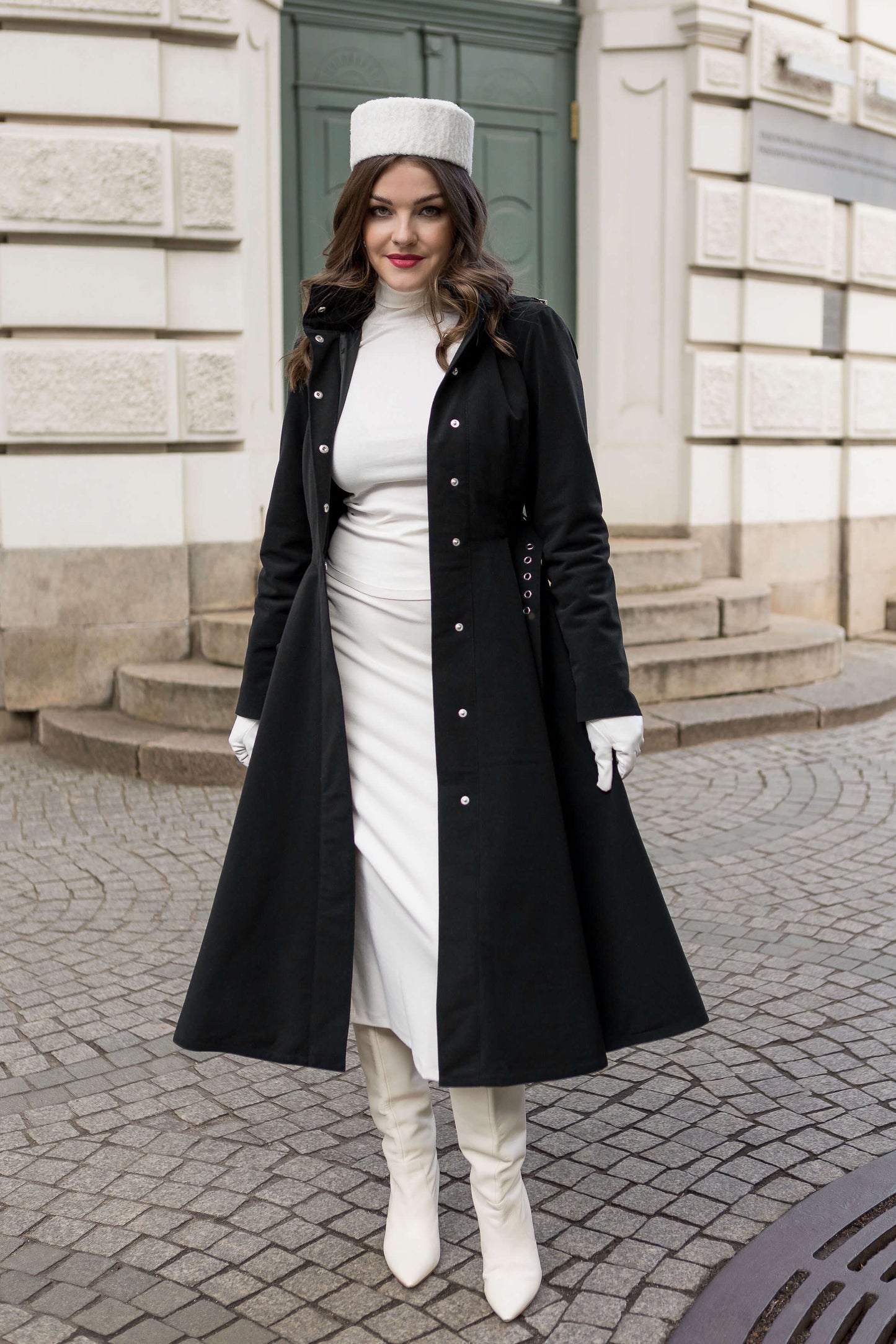 Full-length black winter coat with snap button closure, perfect for casual and elegant looks.
