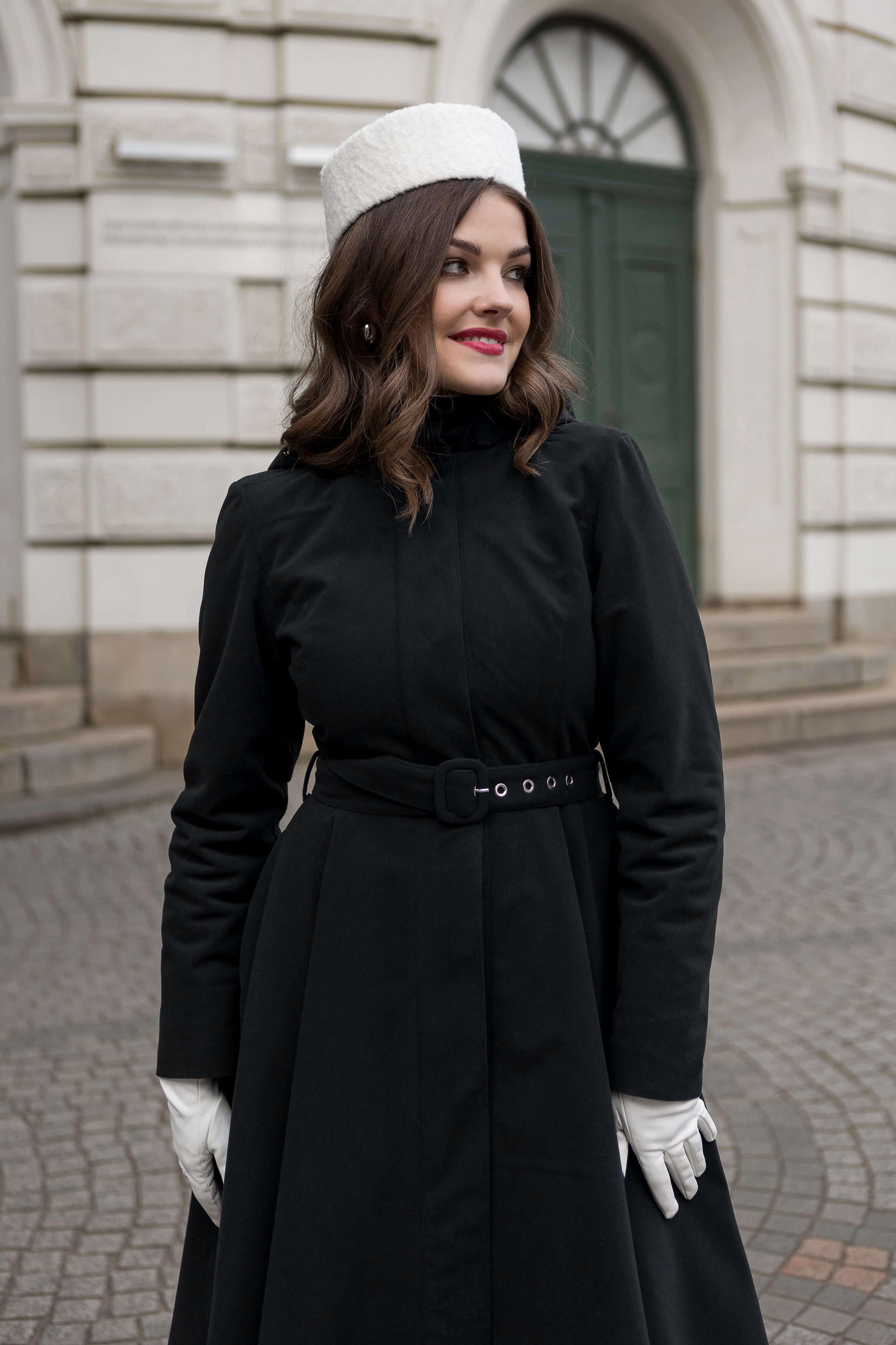 Elegant A-line black coat for women, insulated and waterproof, perfect for cold winter days.