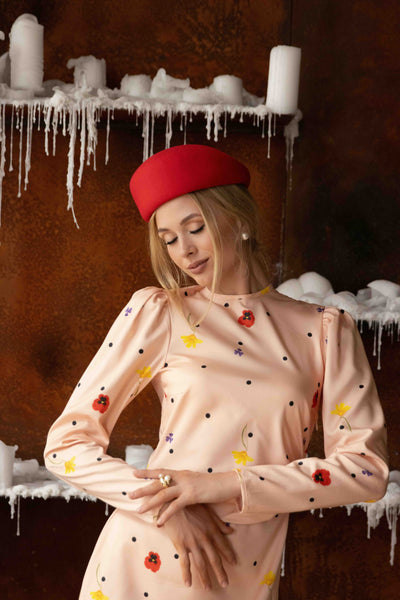 Elegant midi dress in pink with delicate floral accents and polka dots, featuring high neckline and slim feminine fit.