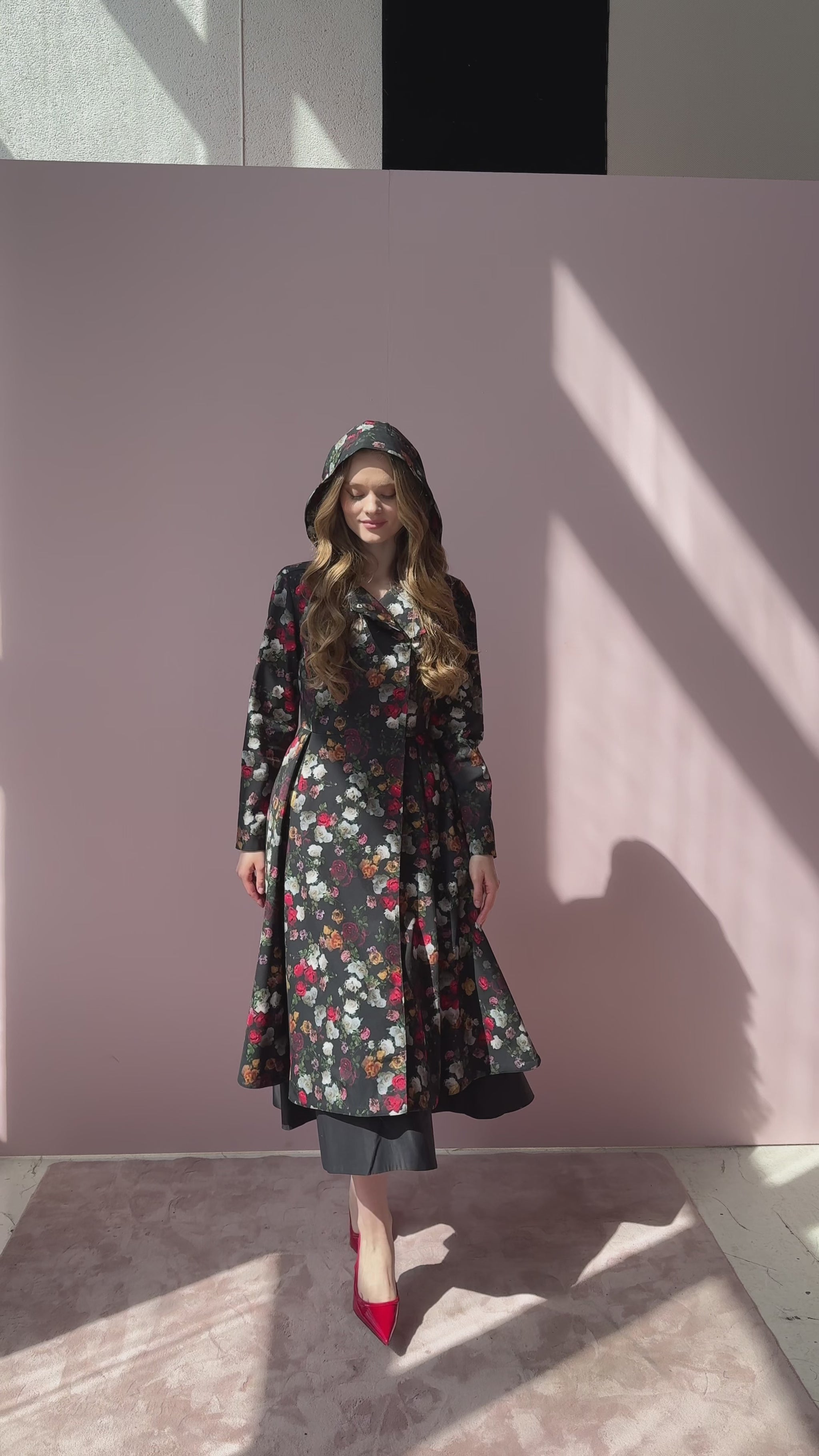 Video still of model walking in Rose Garden coat – floral outerwear in motion, worn with matching tie belt.