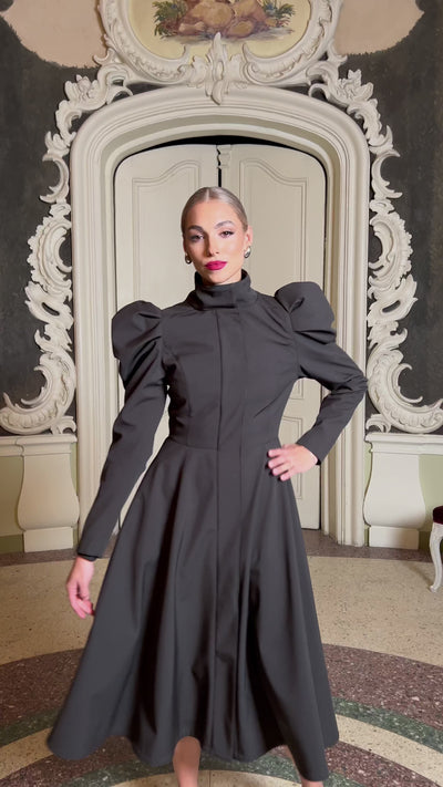 black trench coat with balloon styled sleeves on upper arm