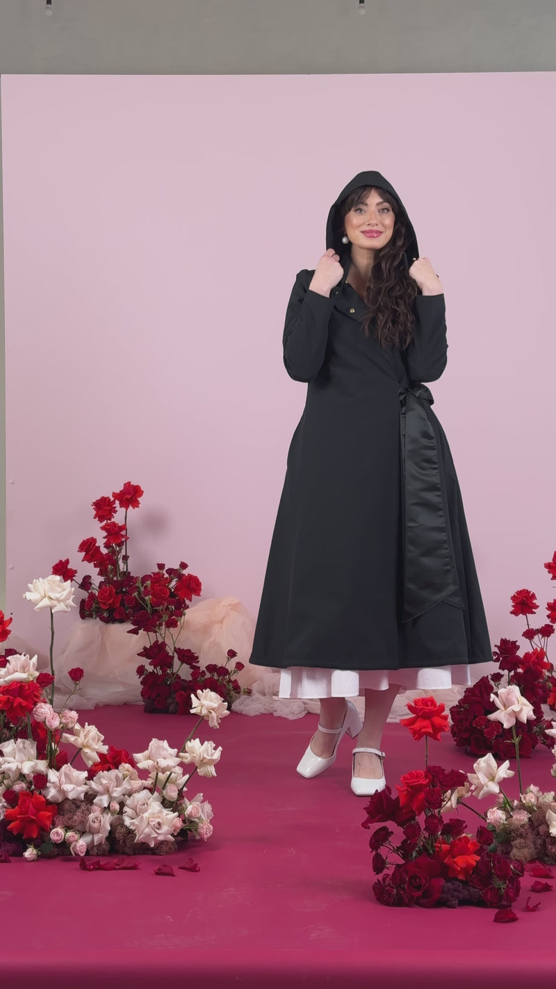 Video of black coat with a black bow in front