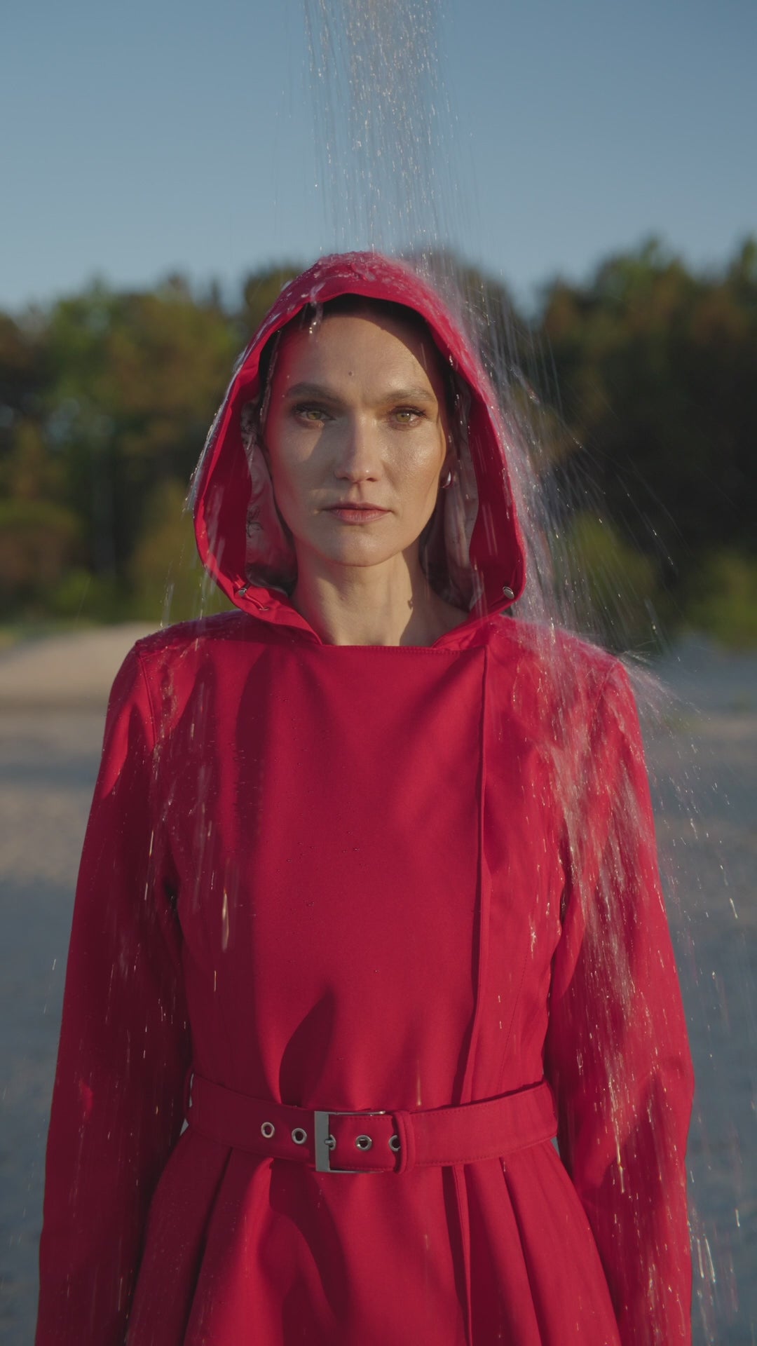 Load video: RainSisters-long-coat-Queen-of-Hearts-and-Majestic-Night-with-pouring-water-hood-on