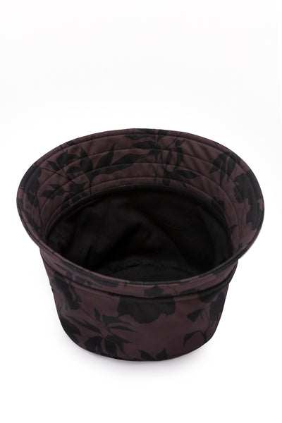 Elegant women's brown bucket hat with a black floral print, made from water-resistant softshell fabric for stylish everyday wear.