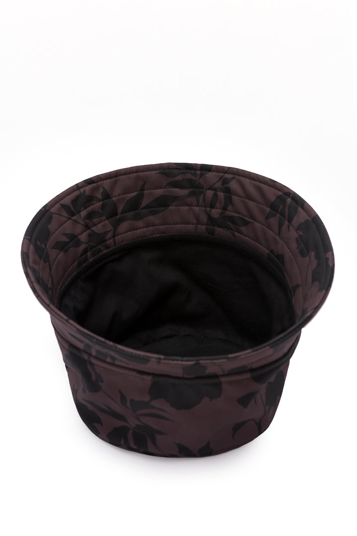 Elegant women's brown bucket hat with a black floral print, made from water-resistant softshell fabric for stylish everyday wear.