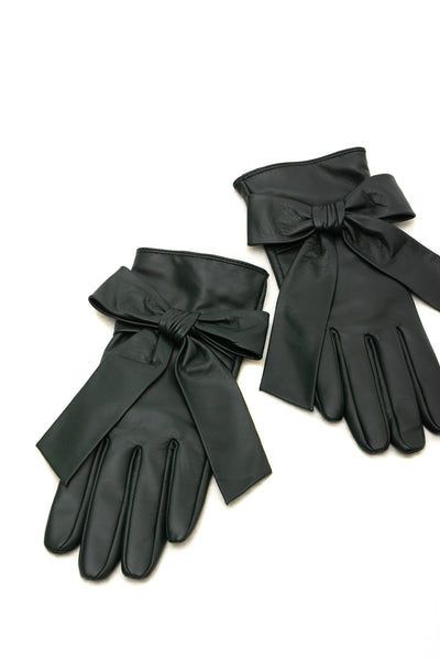 A pair of green leather gloves with wide wrist bows, displayed on a clean white background.