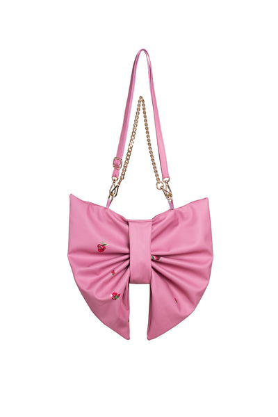 Pink bow-shaped handbag with a chain strap on a white background