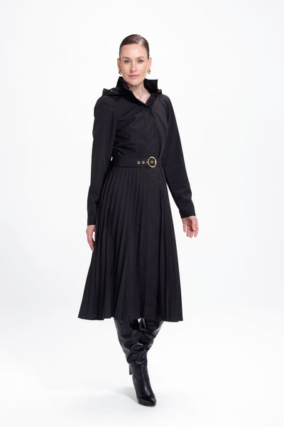Model in motion wearing elegant black fit-and-flare waterproof coat with flowing pleated skirt