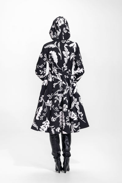 Back view of black floral women's coat with fitted waist and full skirt