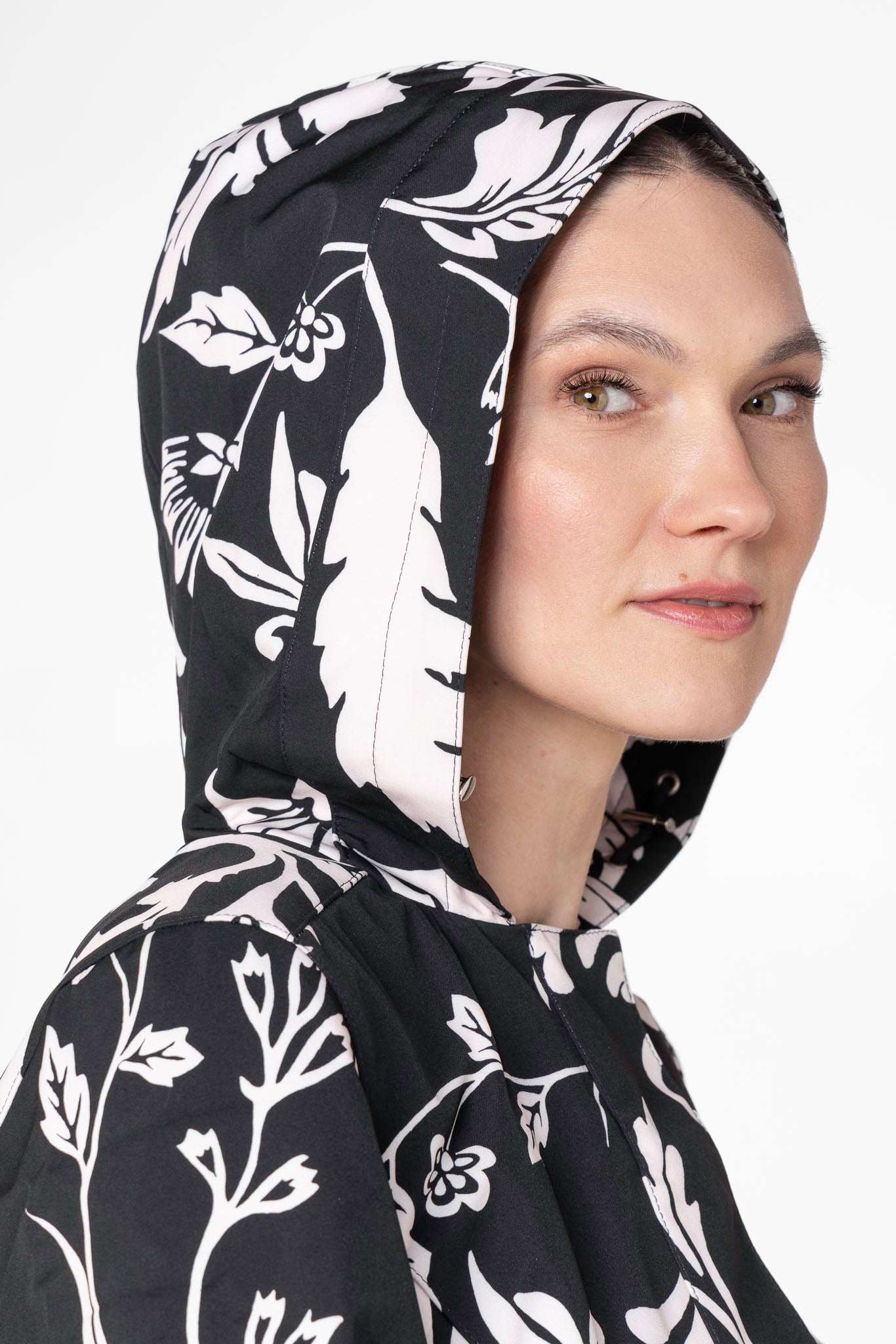 Close-up hood detail on black floral waterproof women's coat