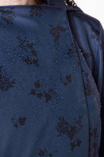 Black floral pattern detail on deep navy women's designer trench coat