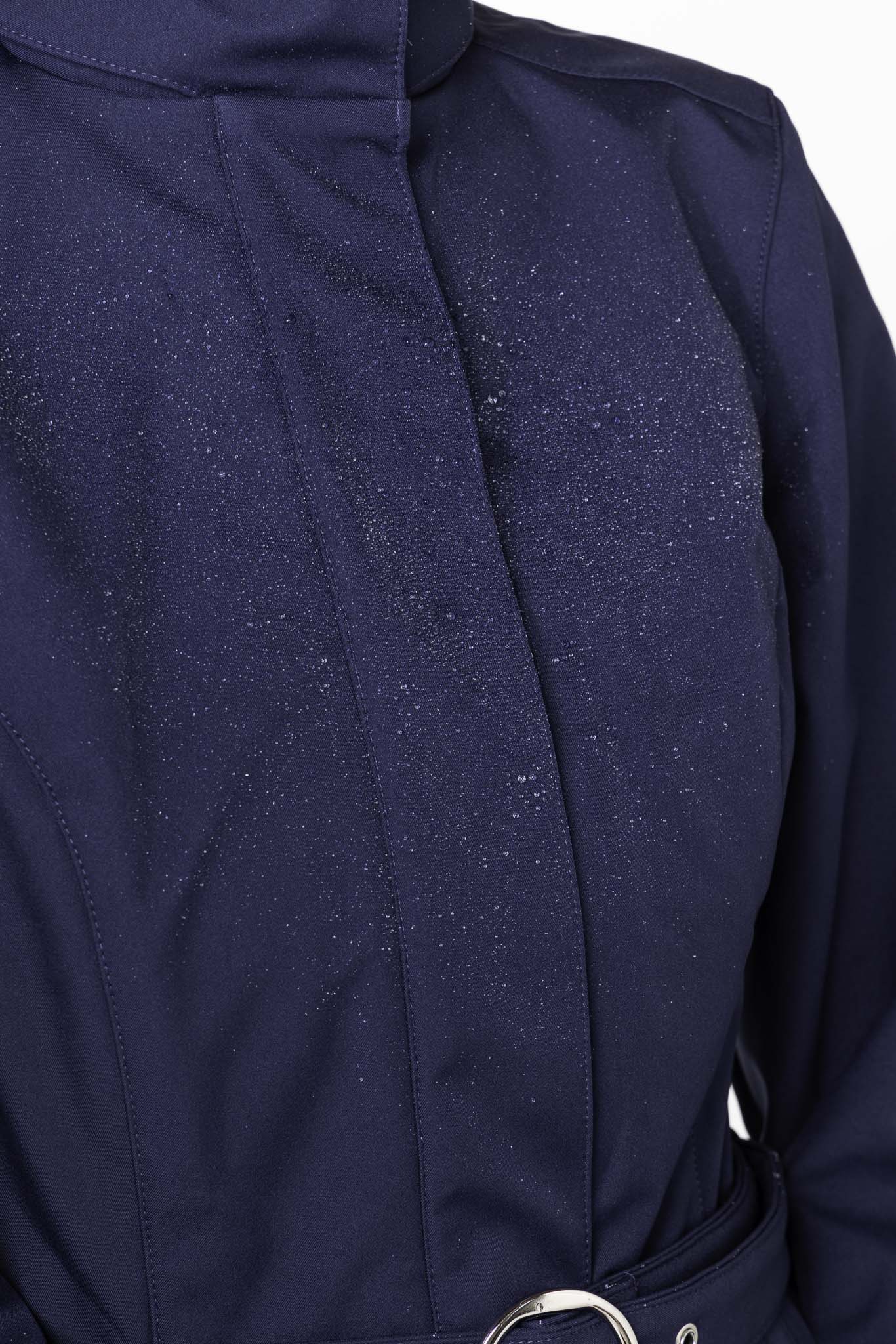 Close-up of structured bodice on deep blue women's designer coat
