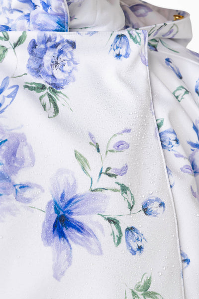 Blue flower and green leaf print detail on white women's designer jacket