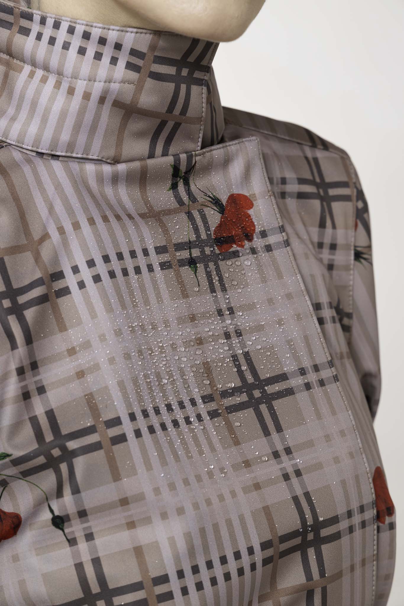 Beige plaid fabric with red floral accents on women's double-breasted trench coat by RainSisters