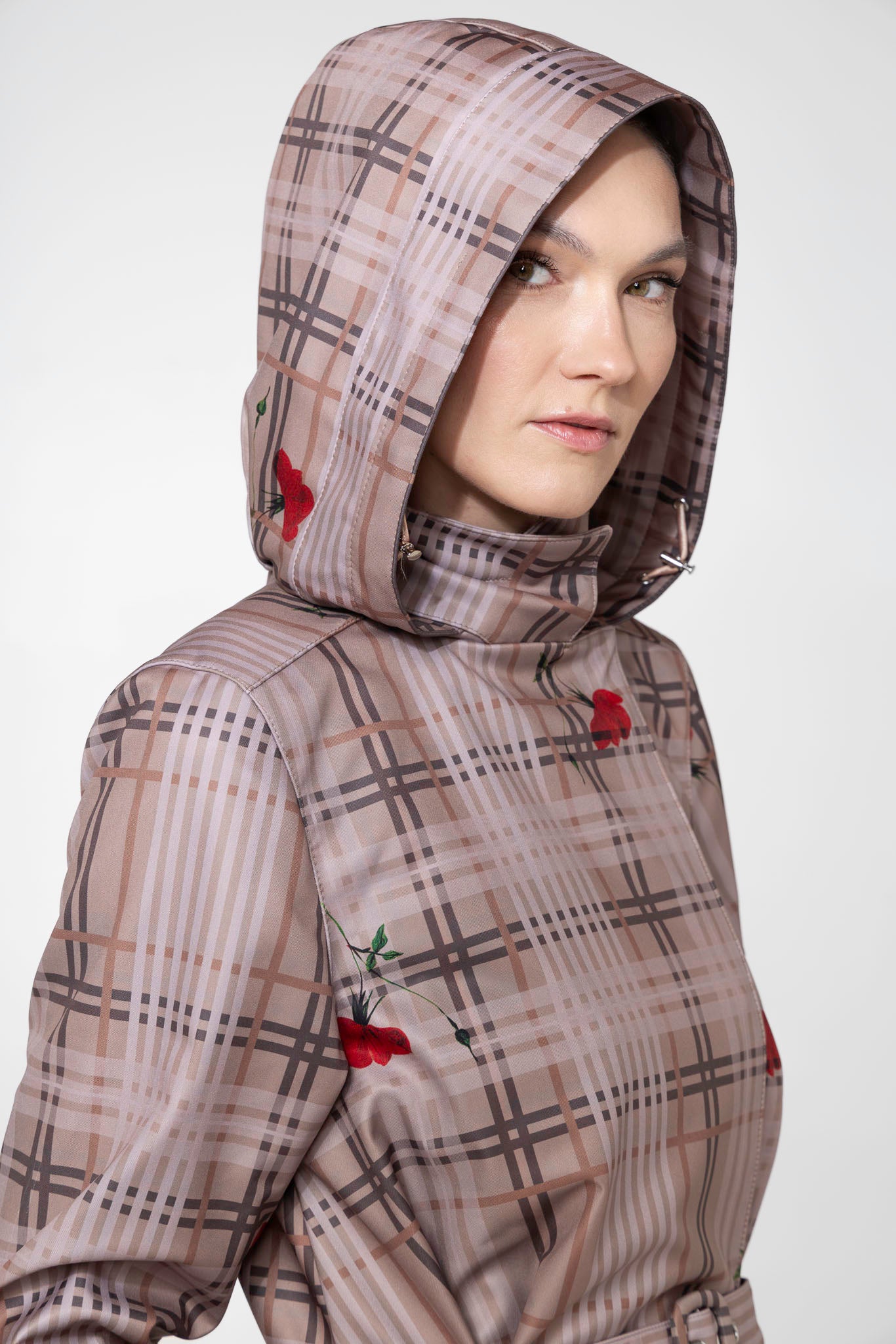 Close-up of hood detail on beige plaid waterproof women's coat with floral print accents