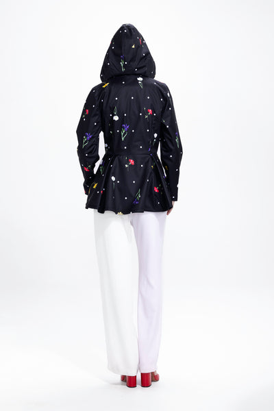 Back view of black women's jacket with colorful floral print and delicate polka dot pattern