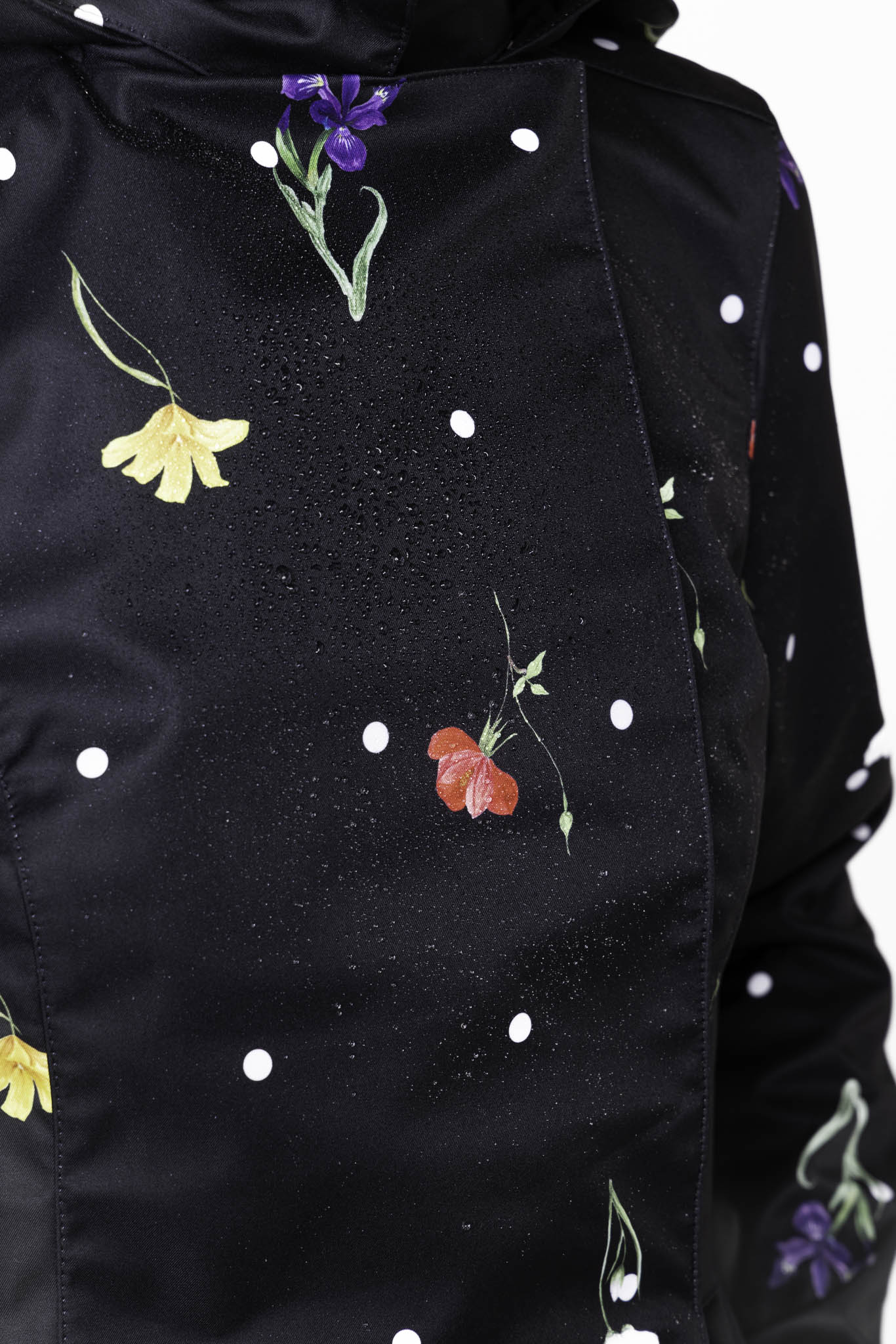 Vibrant floral print and white polka dot detail on black women's designer jacket