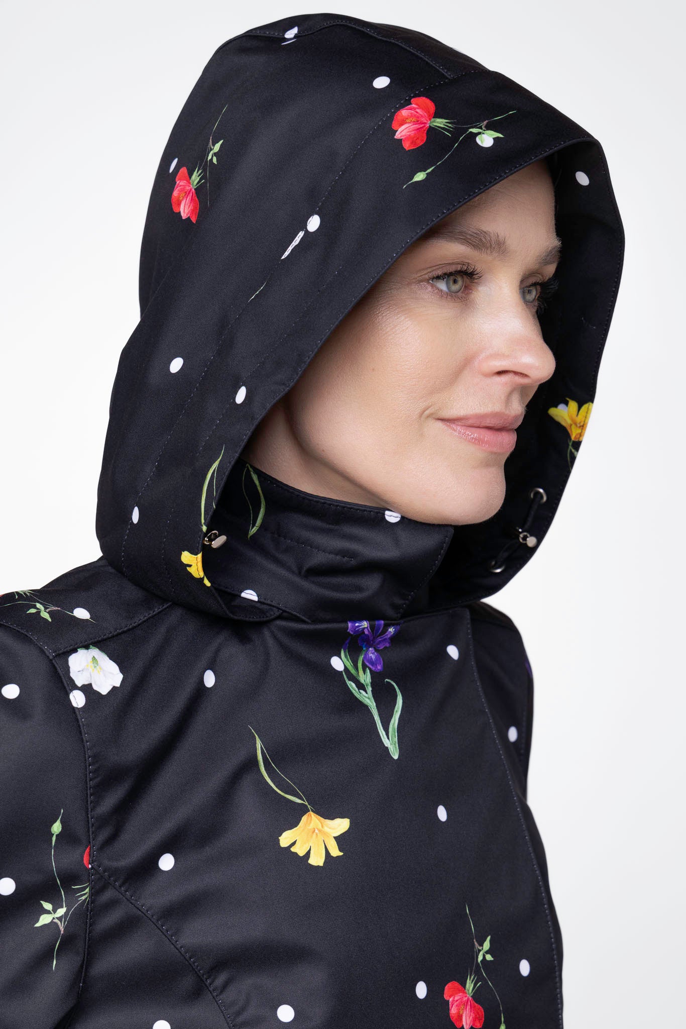 Close-up of detachable hood detail on Cosmic Meadow floral women's rain jacket