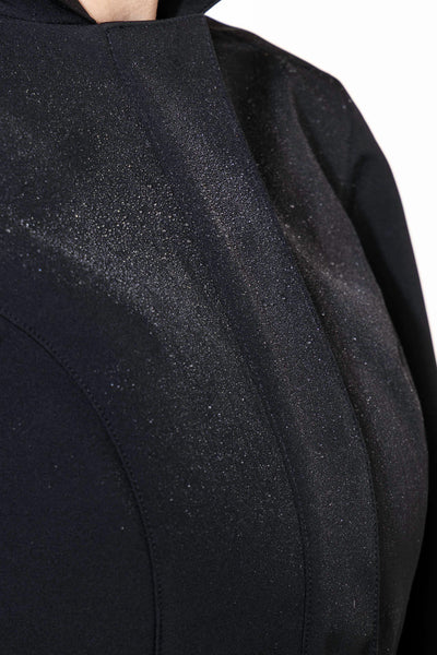 Black tailored outerwear fabric with emerald green satin lining contrast detail on women's coat