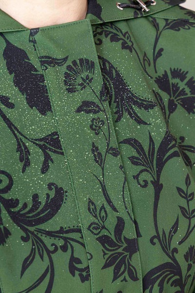 Close-up of dark green floral pattern on women's designer fit and flare coat