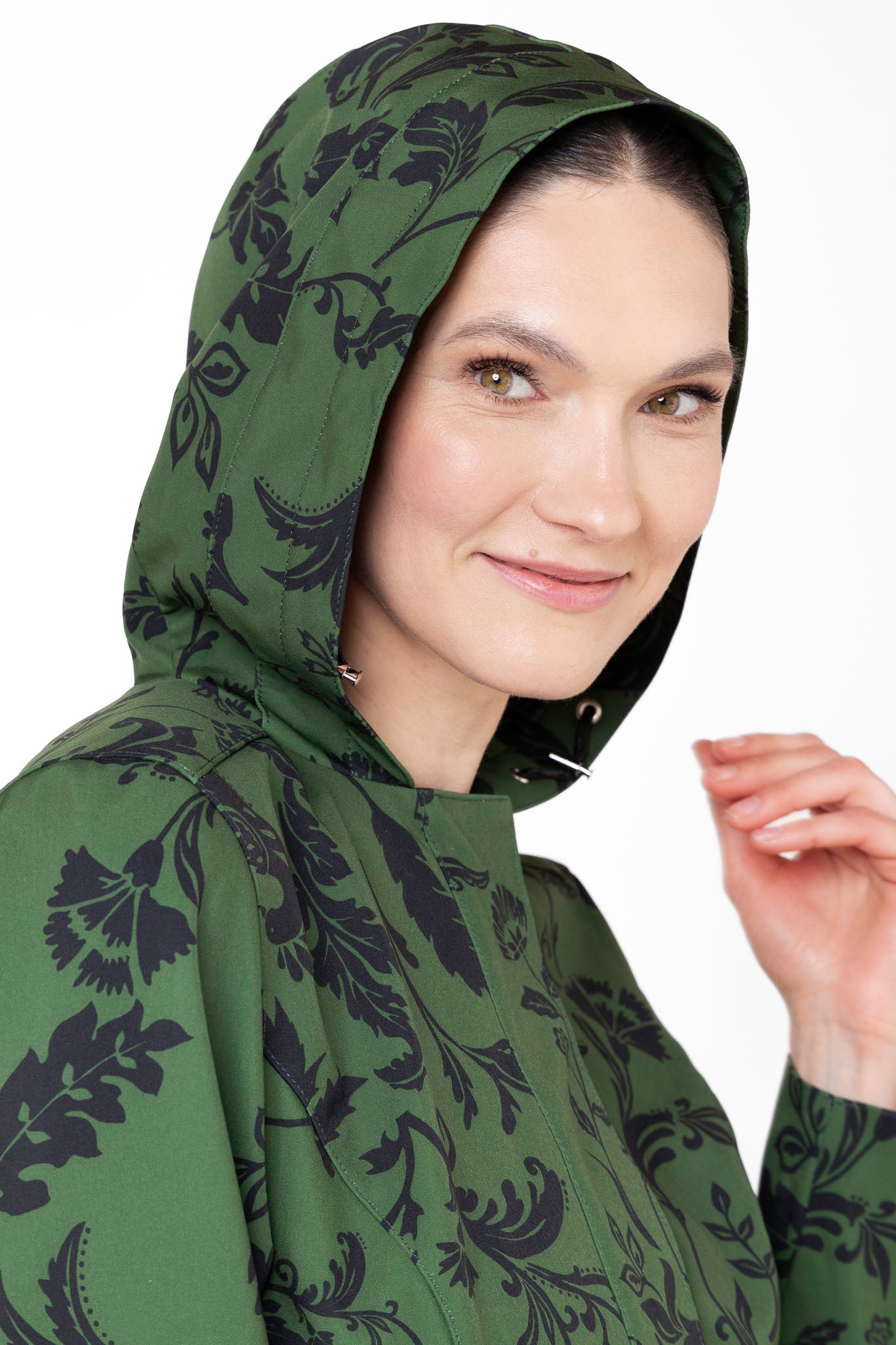 Close-up of hood detail on forest green floral women's waterproof-style coat
