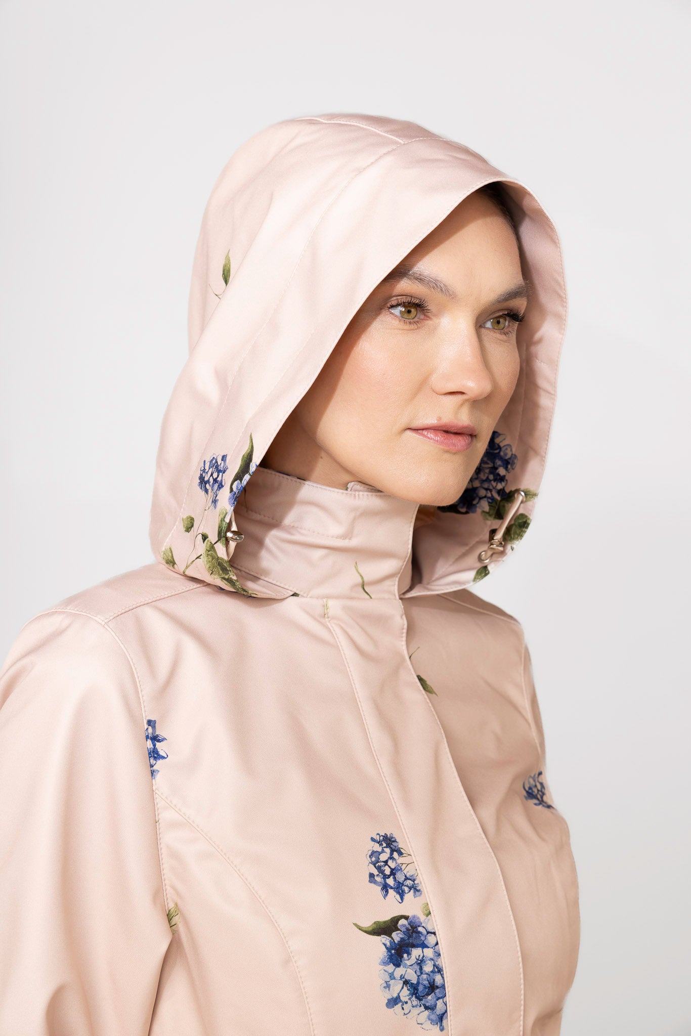Close-up of hood detail on beige waterproof women's coat by RainSisters