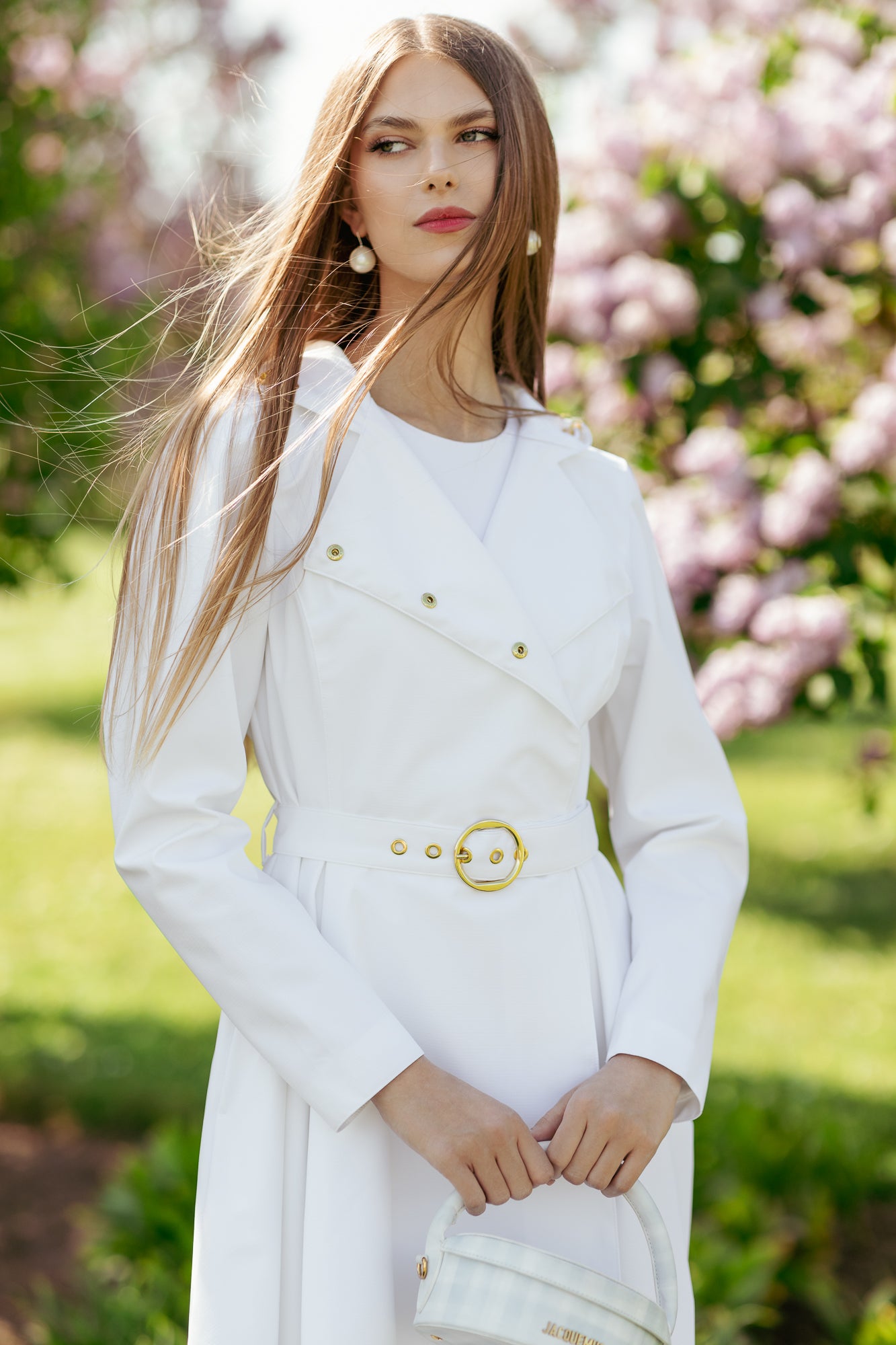Classic double-breasted silhouette on elegant white women's trench coat