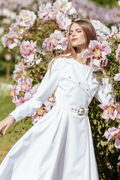 Lightweight white waterproof trench coat worn as chic wedding day and special occasion outerwear