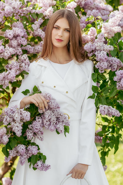 Lightweight water-resistant white fabric on women's designer trench coat