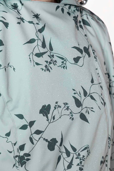 Dark green floral print detail on pastel mint women's designer trench coat