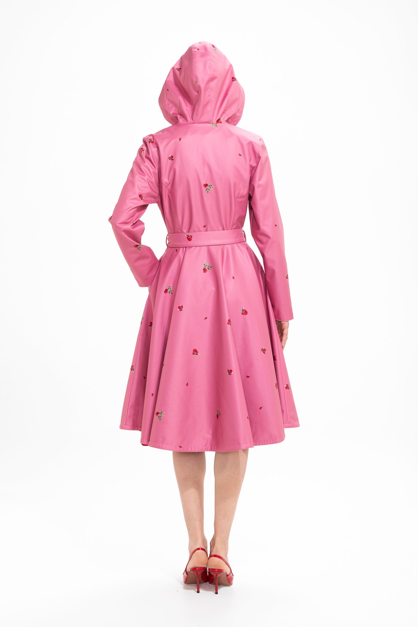 Back view of pink floral women's coat with flared skirt and defined waist fit