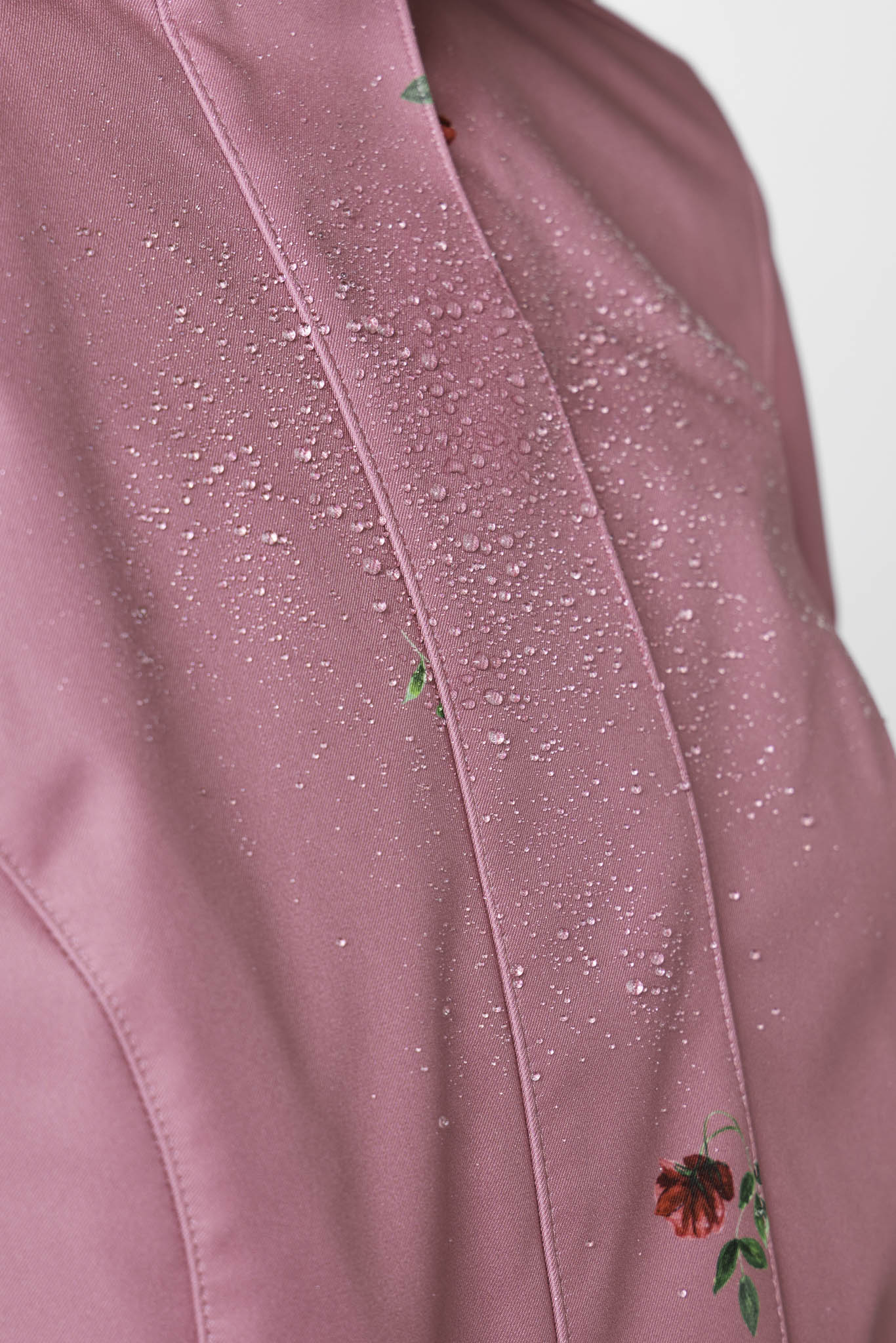 Close-up of pink floral pattern on soft water-resistant women's fit and flare coat by RainSisters
