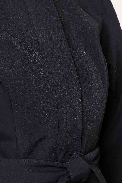 Black tailored outerwear waterproof fabric with striking red lining detail on women's coat