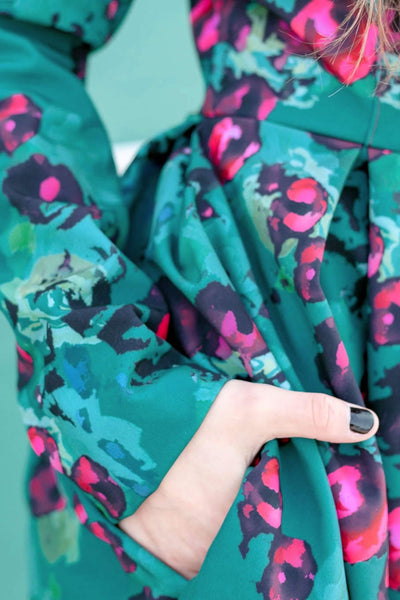 Green floral print detail on elegant fit and flare women's trench coat
