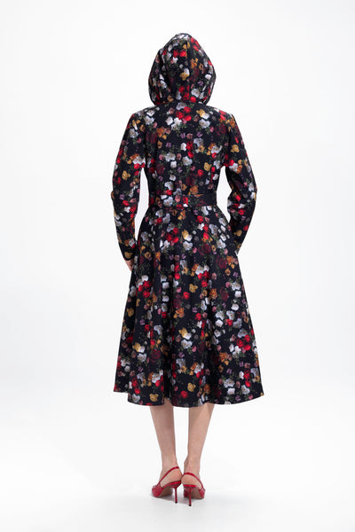 Back view of black romantic rose print women's coat with structured waist silhouette