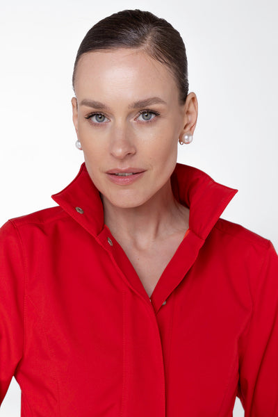 Close-up of structured bodice on red women's designer trench coat