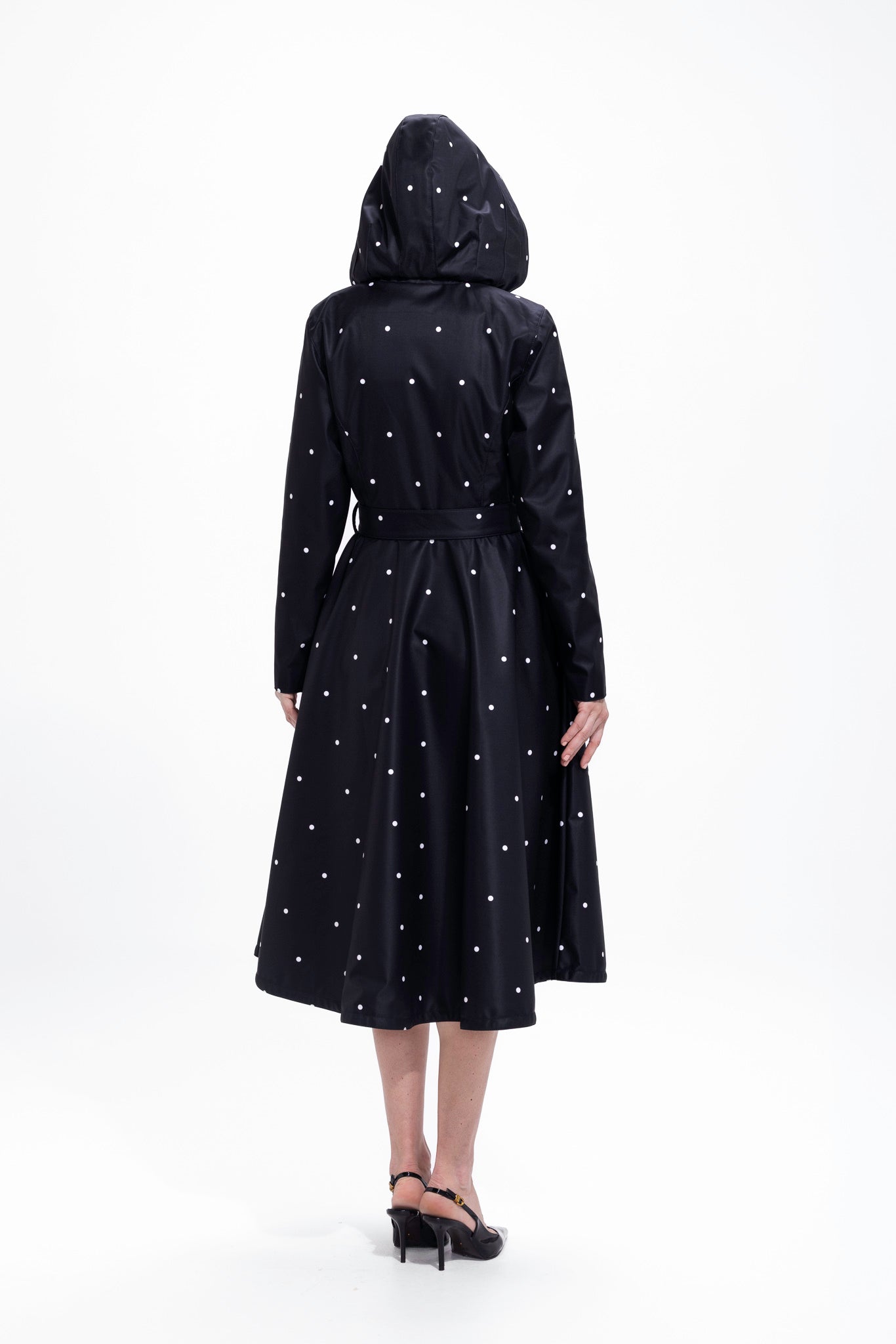 Back view of black women's coat with fitted waist and flared skirt silhouette