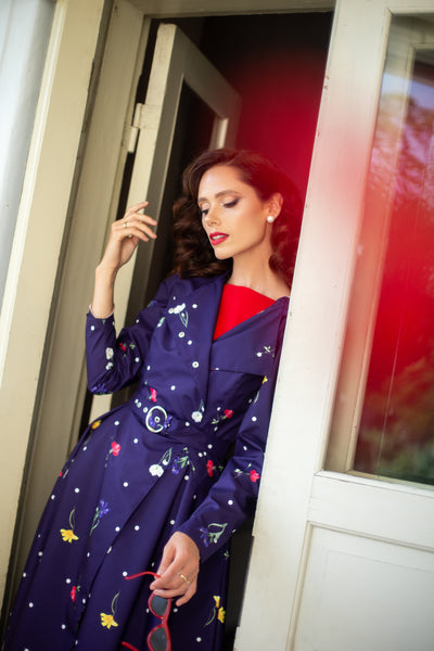 Lightweight purple floral raincoat worn as feminine garden party and spring outerwear