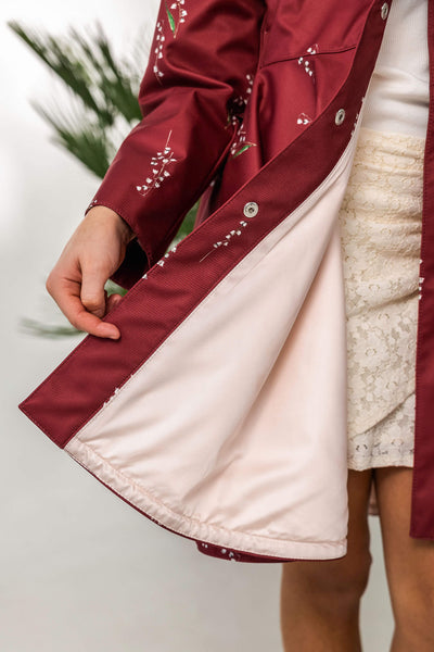 Close-up of a red coat with pink satin lining 