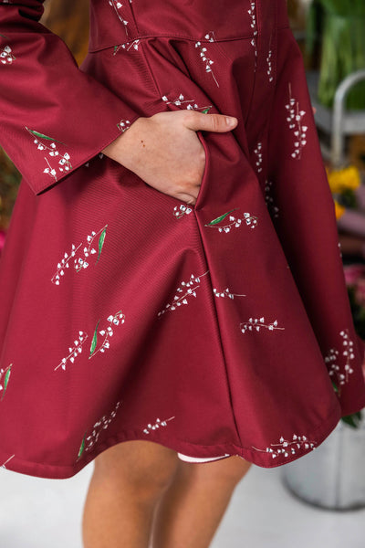 Red floral print girl coat with hidden side pockets.