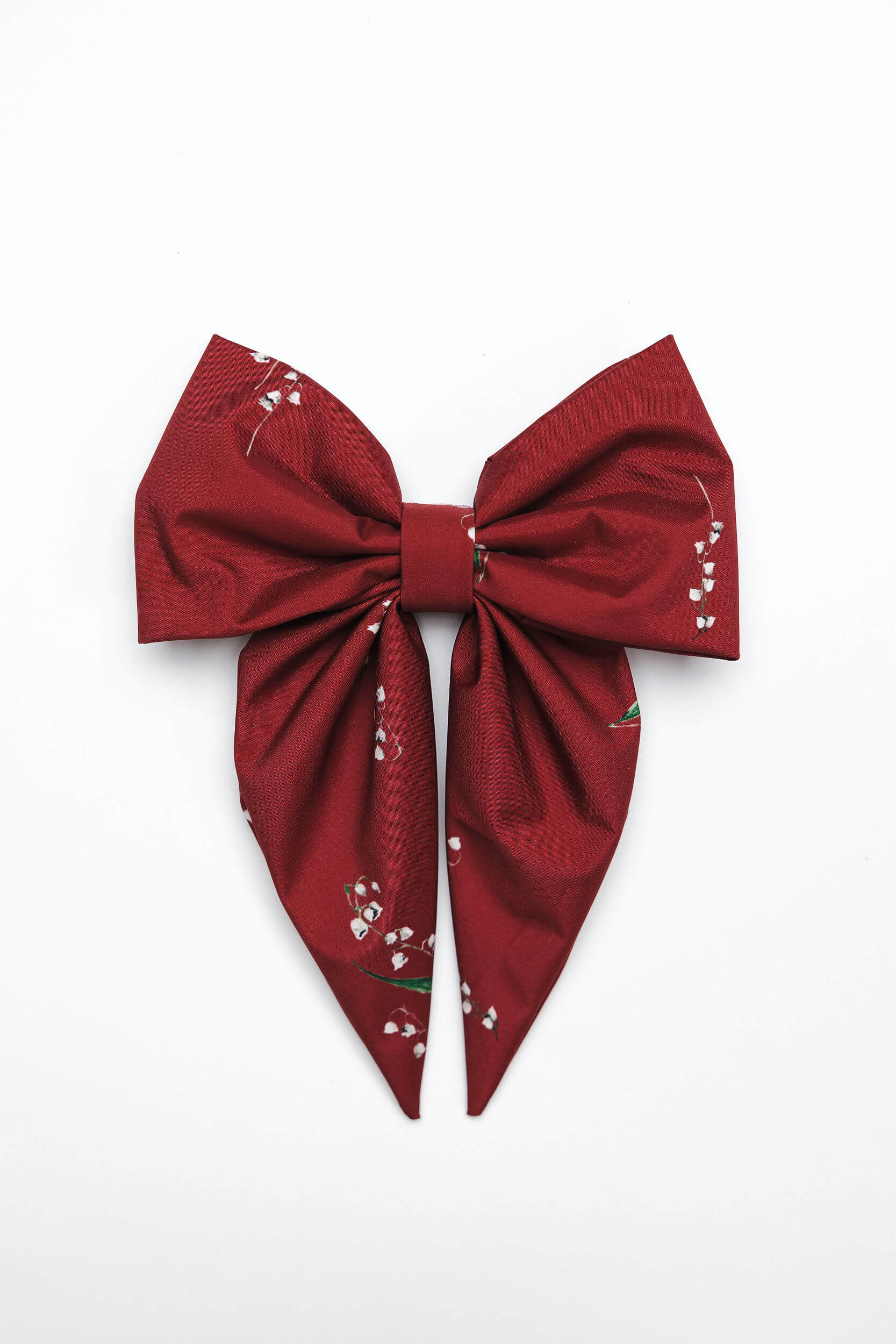 Red bow with floral patterns on a white background