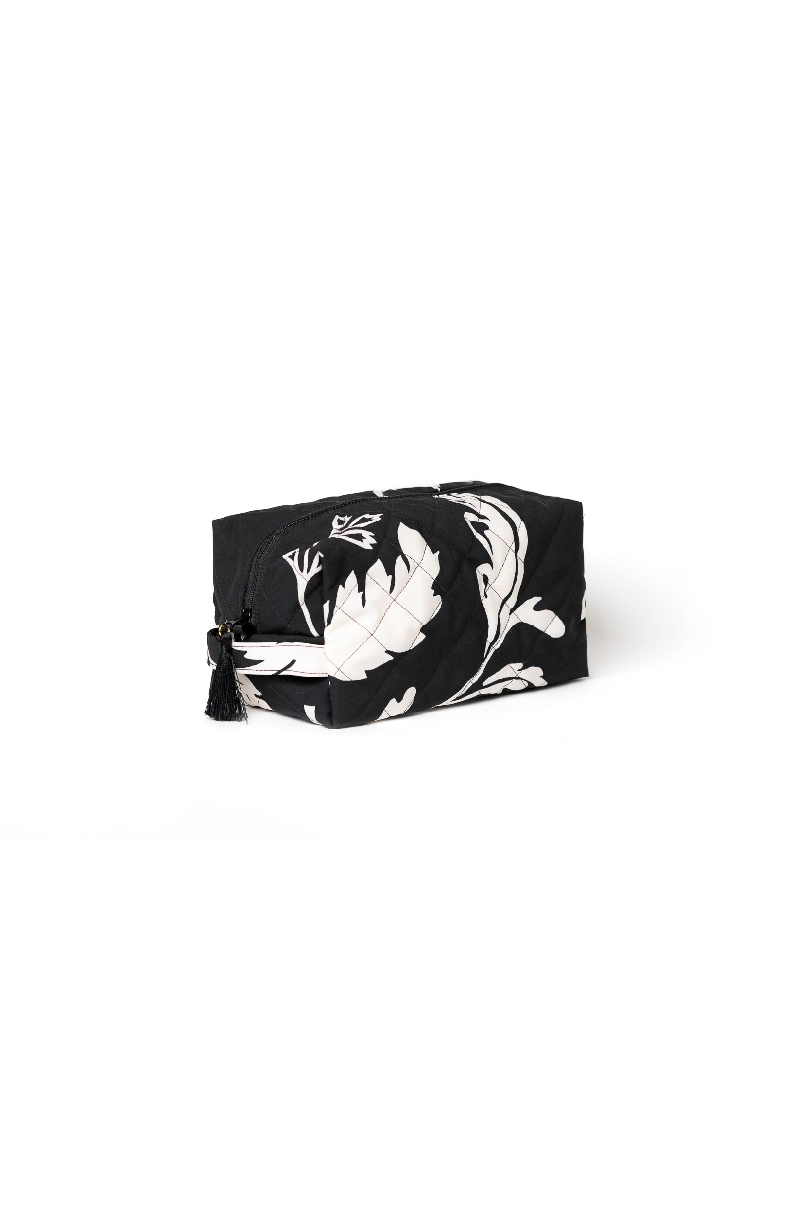 Large black cosmetic bag with white floral print, black zipper closure, and decorative tassel detail