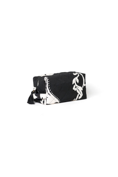 Small black cosmetic bag with white floral print, black zipper, and tassel detail for makeup, skincare, and travel accessories