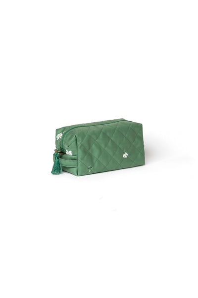 Small soft green floral cosmetic bag with green zipper and tassel detail for makeup, skincare, and travel accessories