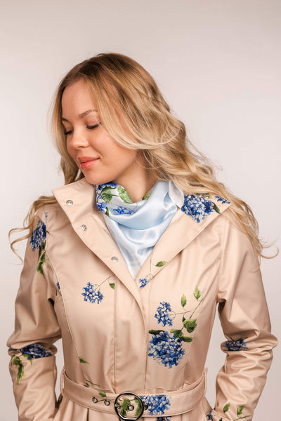 Light blue silk scarf styled around the neck
