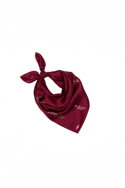 Red scarf with floral print on a white background