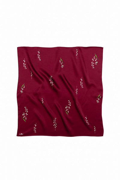 Red fabric with small floral patterns on a white background
