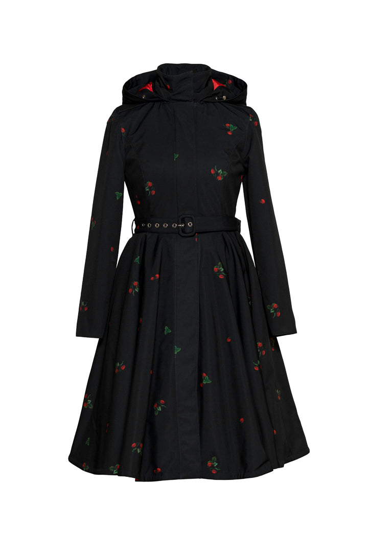Black winter fit-and-flare coat with delicate strawberry print and contrasting red satin lining by Rainsisters.