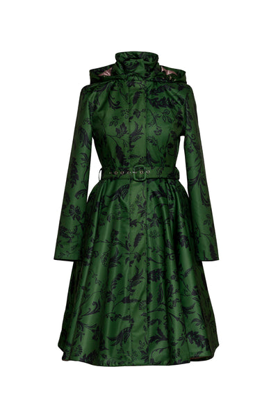 A green long-sleeve coat with a black floral pattern, featuring a high structured collar, a matching waist belt, and a flared skirt, shown against a plain white background.